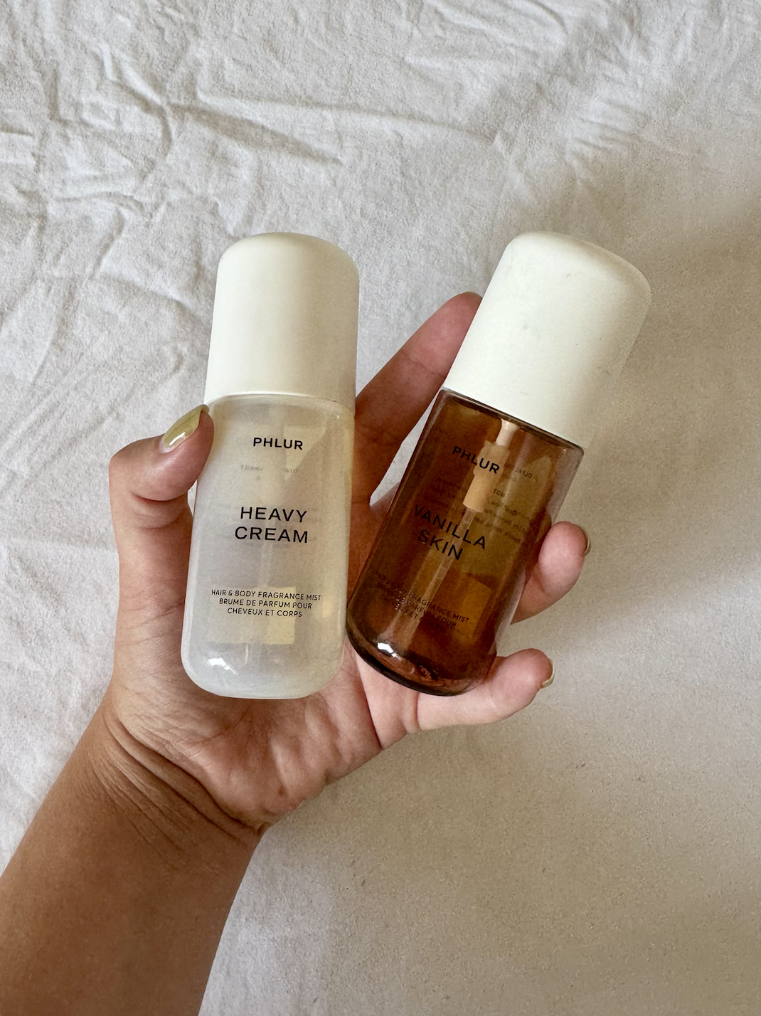 phlur-heavy-cream-vanilla-skin-fragrance-mists | Live That Glow PHLUR Heavy Cream and Vanilla Skin hair and body fragrance mists held in hand