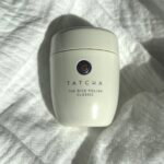 Tatcha The Rice Polish Classic photographed on white fabric for our review