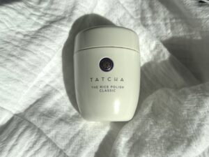 Tatcha The Rice Polish Classic photographed on white fabric for our review