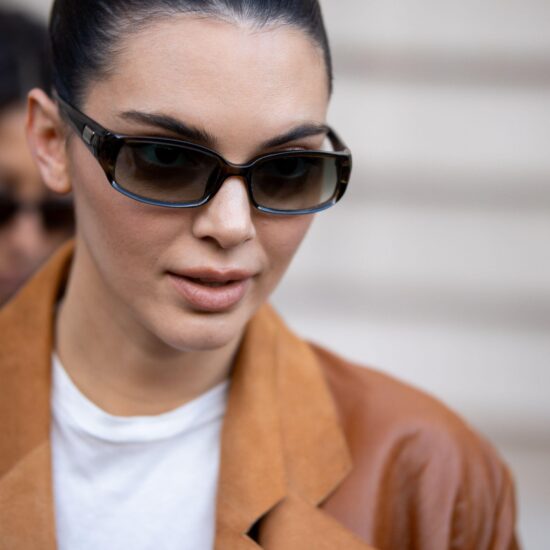 Kendall Jenner wearing sunglasses with glowing skin