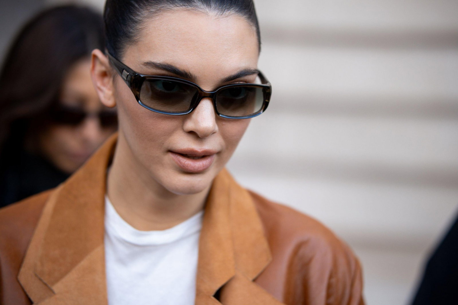 Kendall Jenner wearing sunglasses with glowing skin