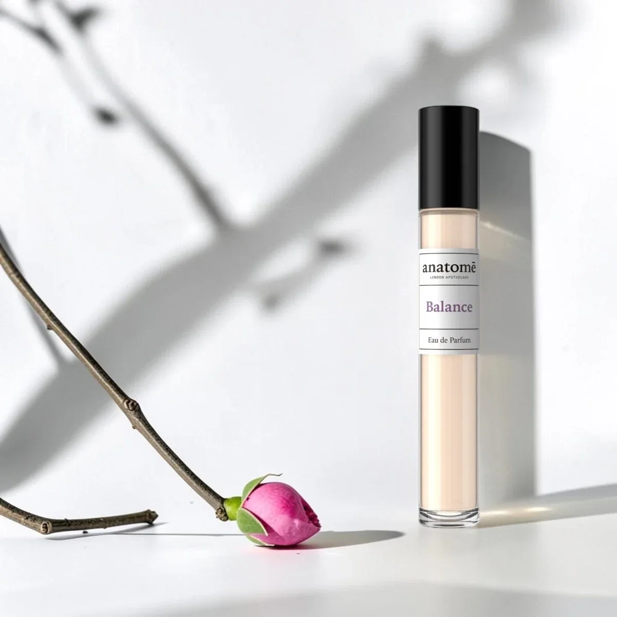 anatome-balance-eau-de-parfum | Live That Glow anatom? Balance Eau de Parfum with a pink rose on a white background