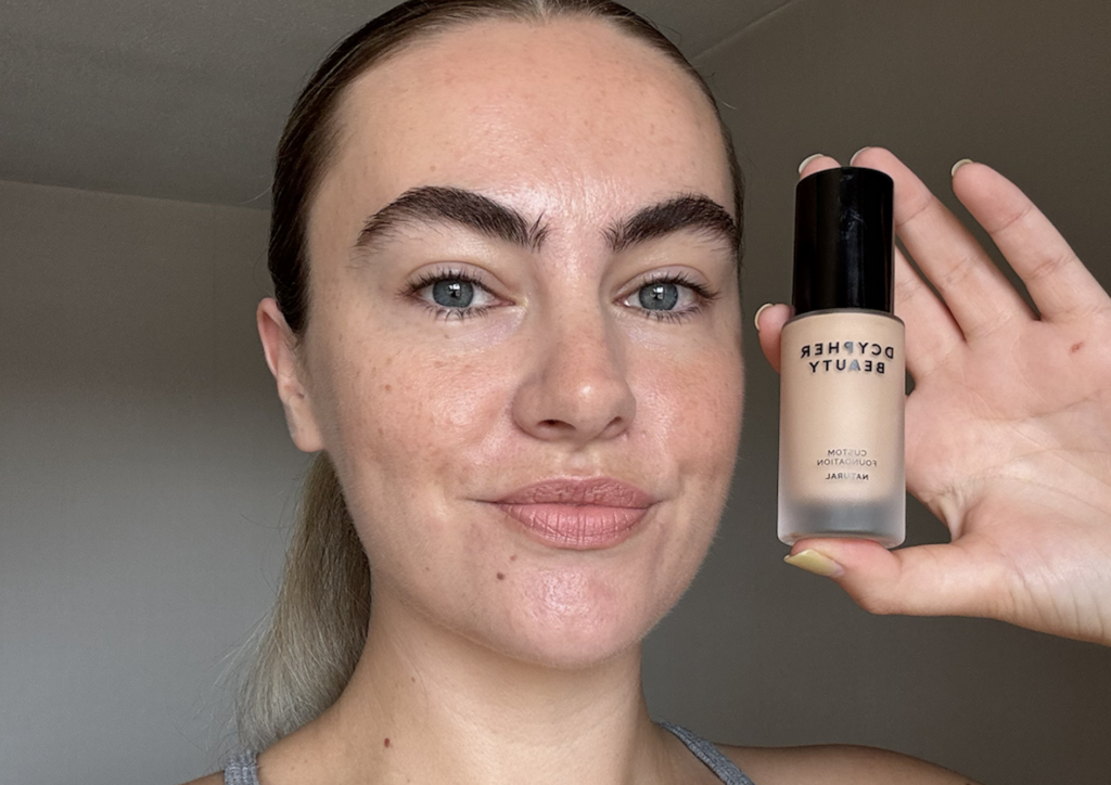 Alice wearing and holding DCYPHER Natural Custom Foundation