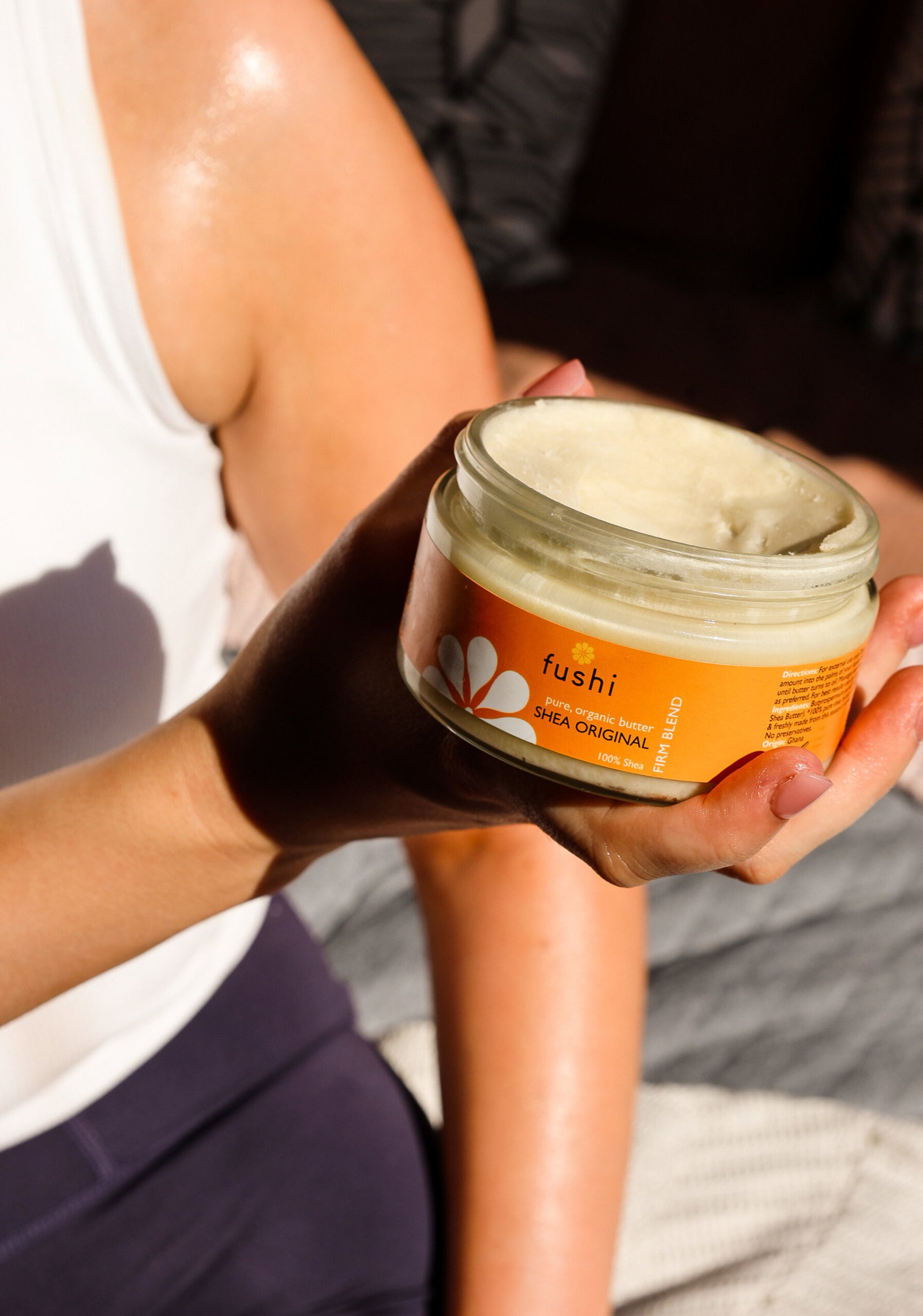 Fushi organic shea butter held in a person's hand