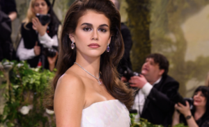 Kaia Gerber wearing her long brunette hair in a smooth, glossy blowout