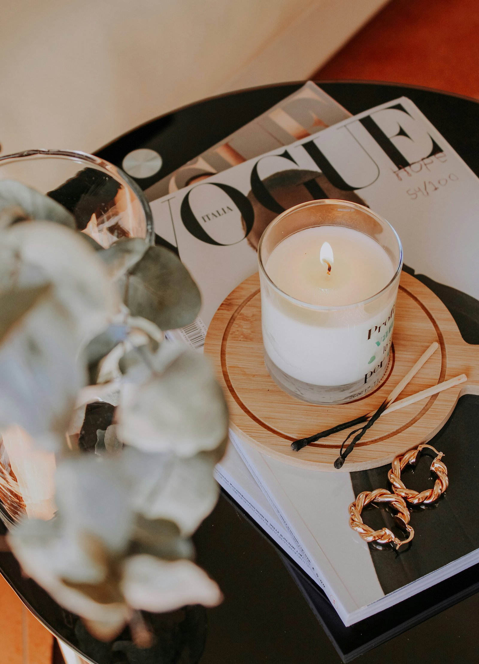 Lit candle creating a relaxing atmosphere for an at-home spa evening