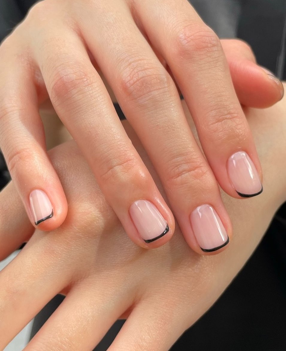 Short natural pink nails with delicate black micro-French tips