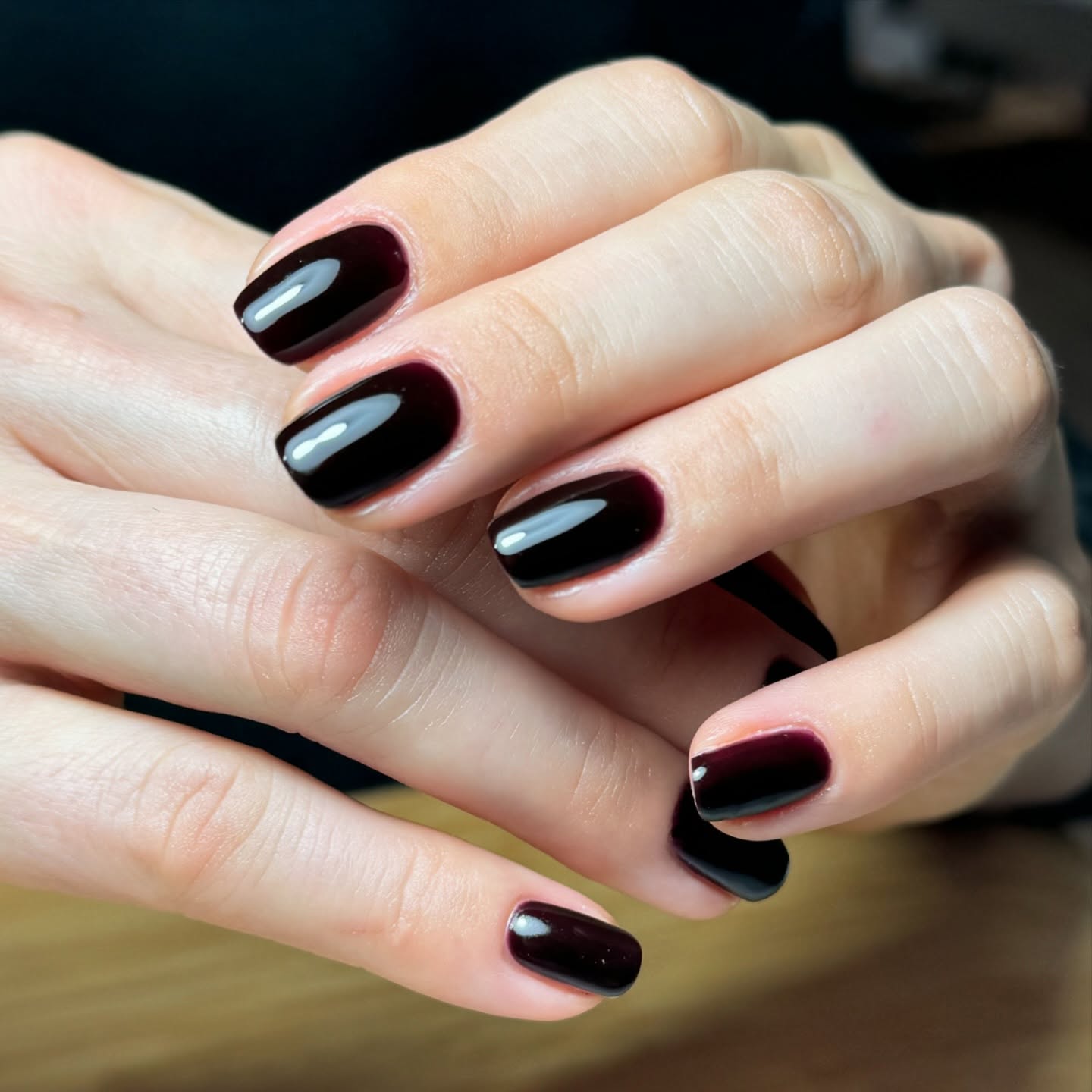 Glossy black cherry nails in a deep red autumn shade.
