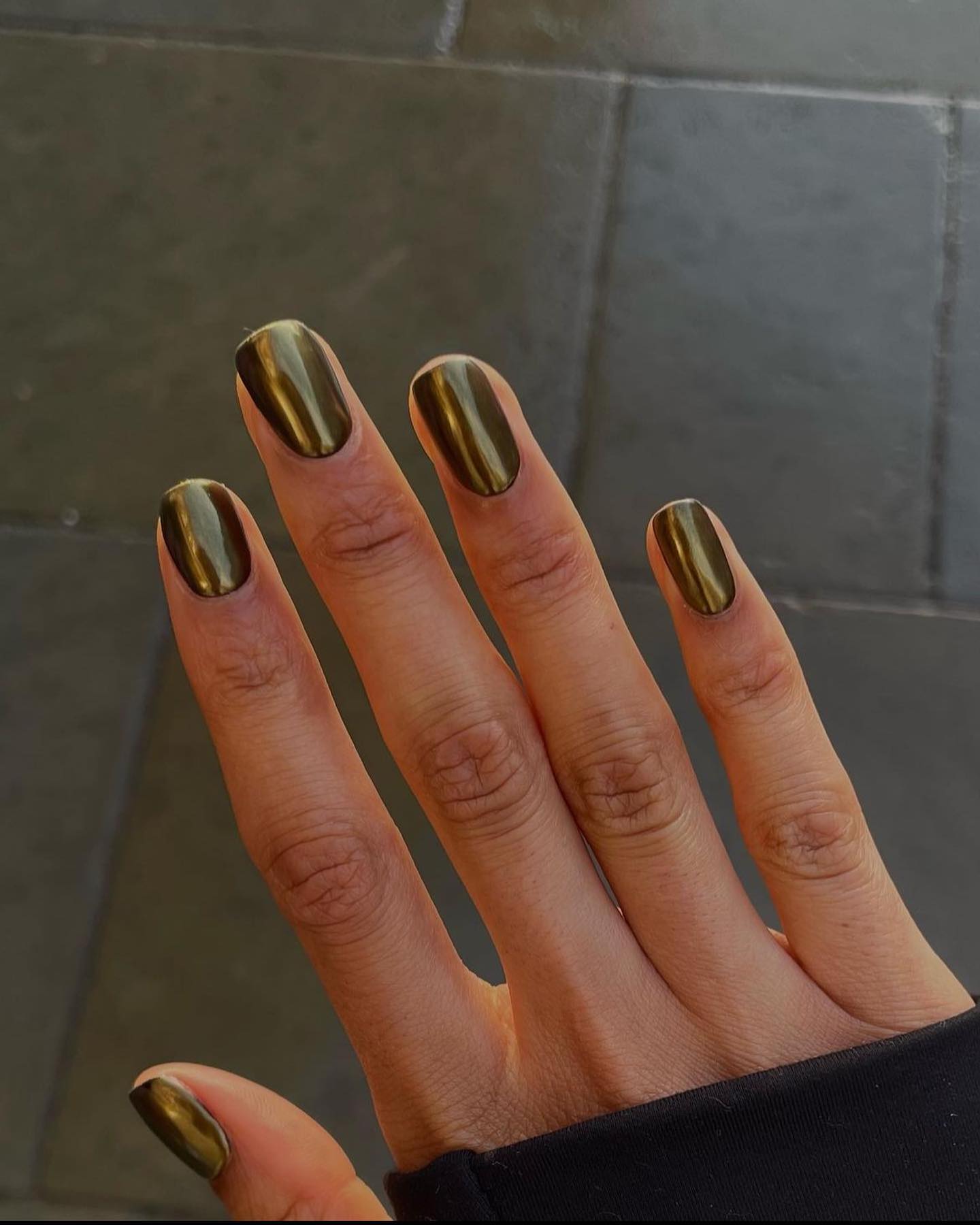 Olive green chrome nails with a glossy metallic finish.