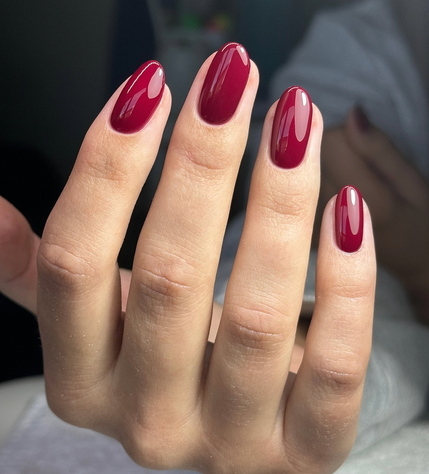 Glossy cherry red oval nails for a classic autumn manicure.