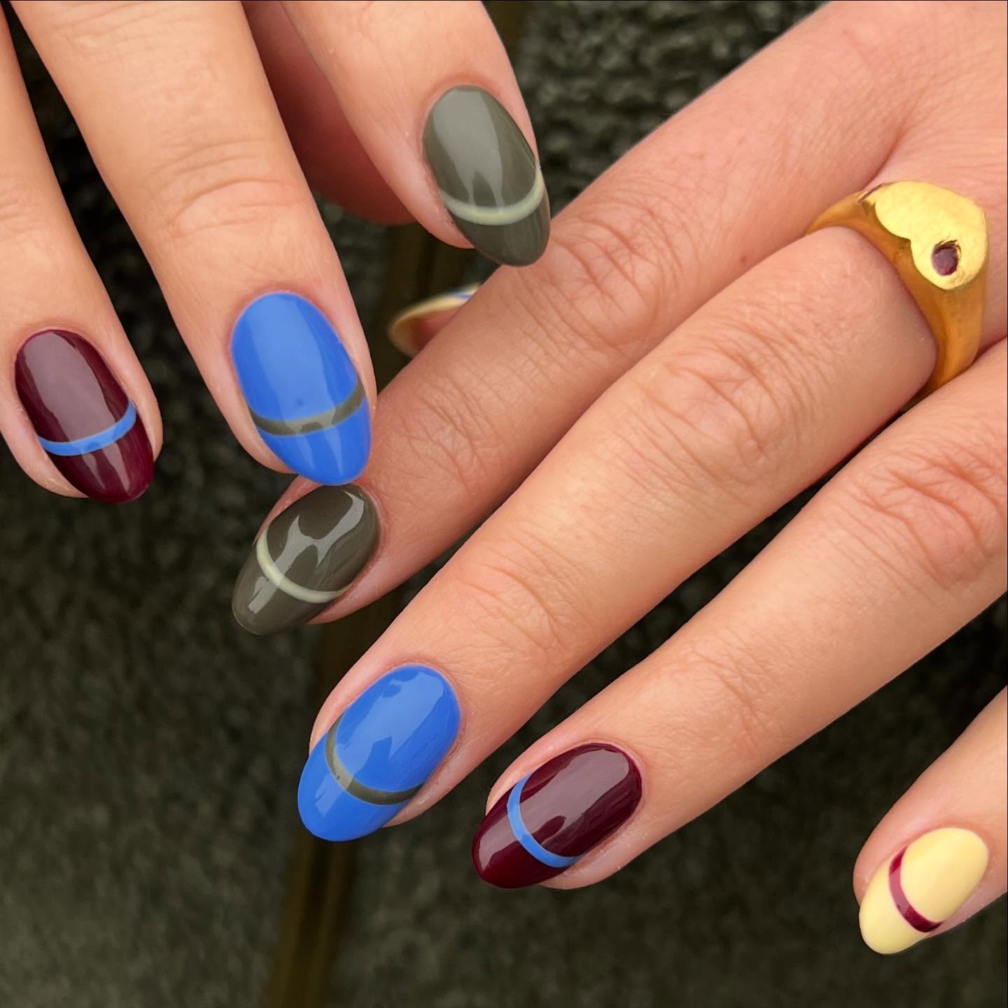 Colourful oval autumn nails featuring warm seasonal shades.