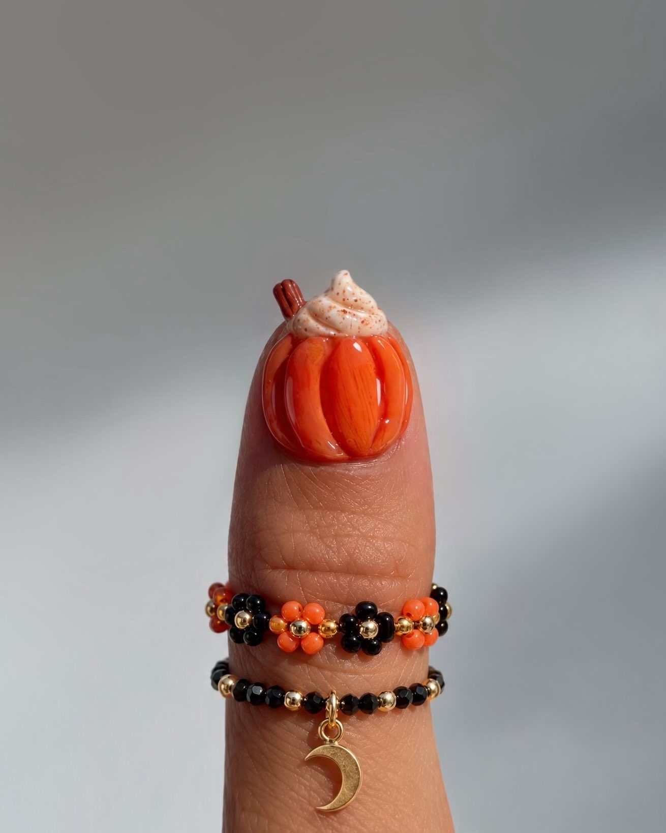 Orange 3D pumpkin nail art topped with whipped cream and a cinnamon stick for Halloween