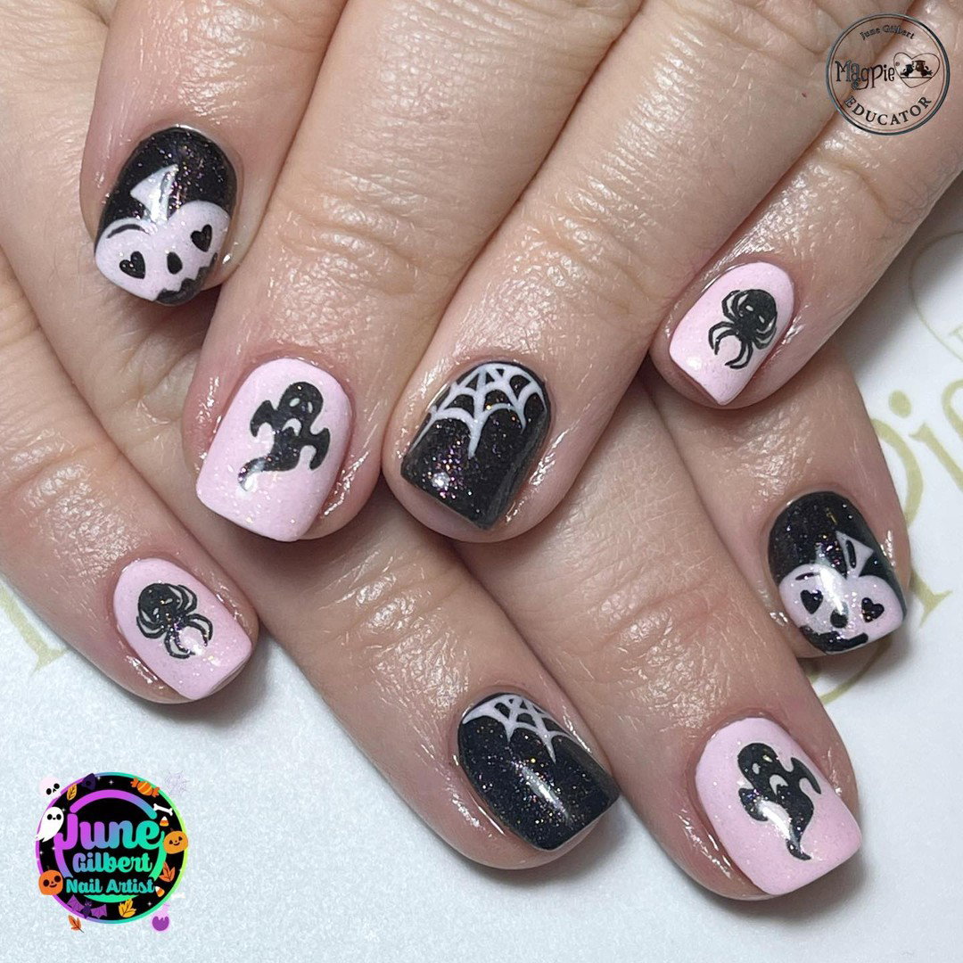 Pink and black Halloween nails decorated with ghosts, spiders, cobwebs and glitter