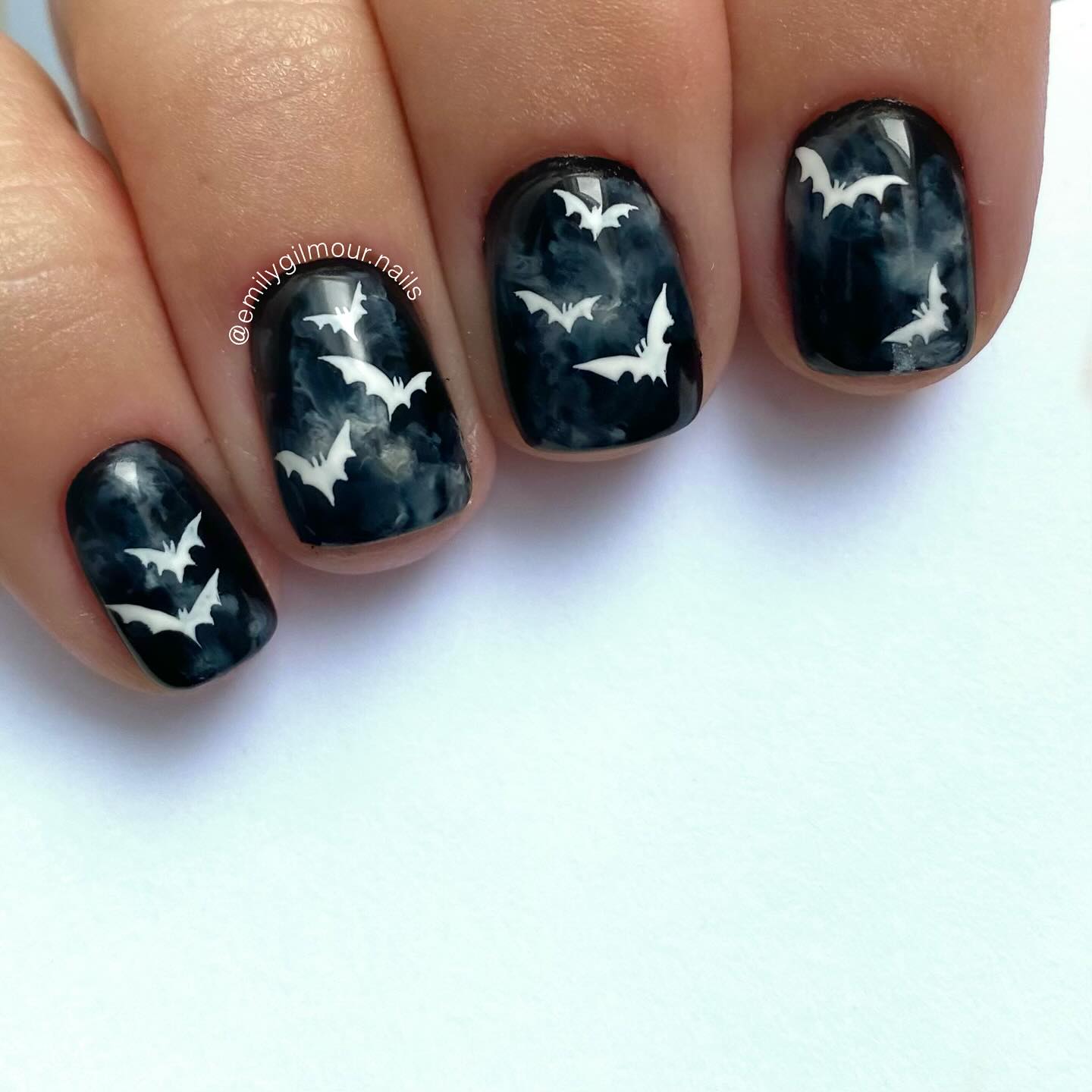 Short square Halloween nails with smoky black and grey marble effects and white bats