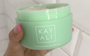 Kayali Yum Pistachio Gelato body cream held in hand during testing