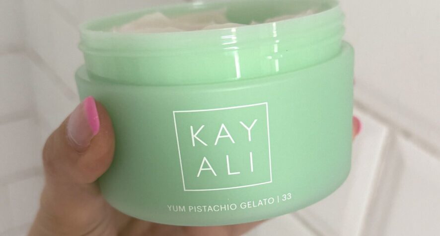 Kayali Yum Pistachio Gelato body cream held in hand during testing