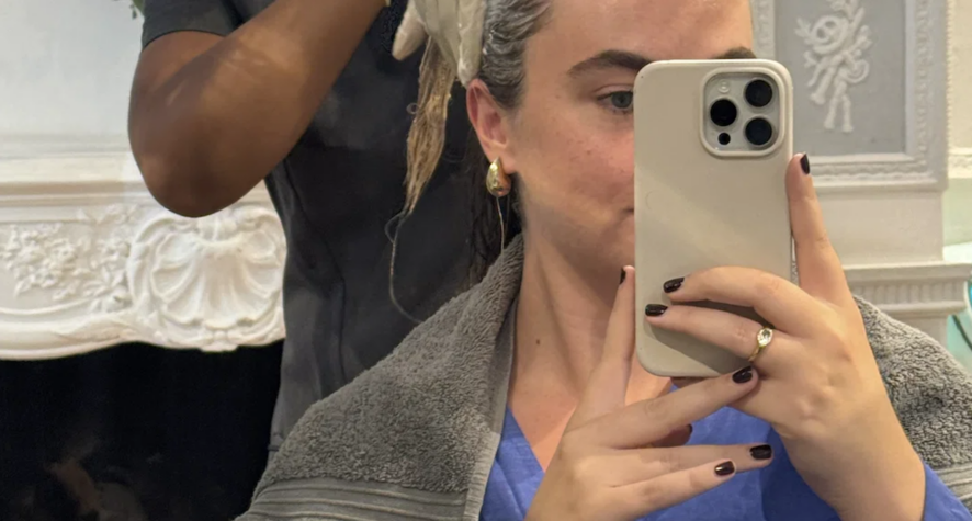Close-up of a therapist massaging an exfoliating cream into the scalp during a Philip Kingsley hair treatment.